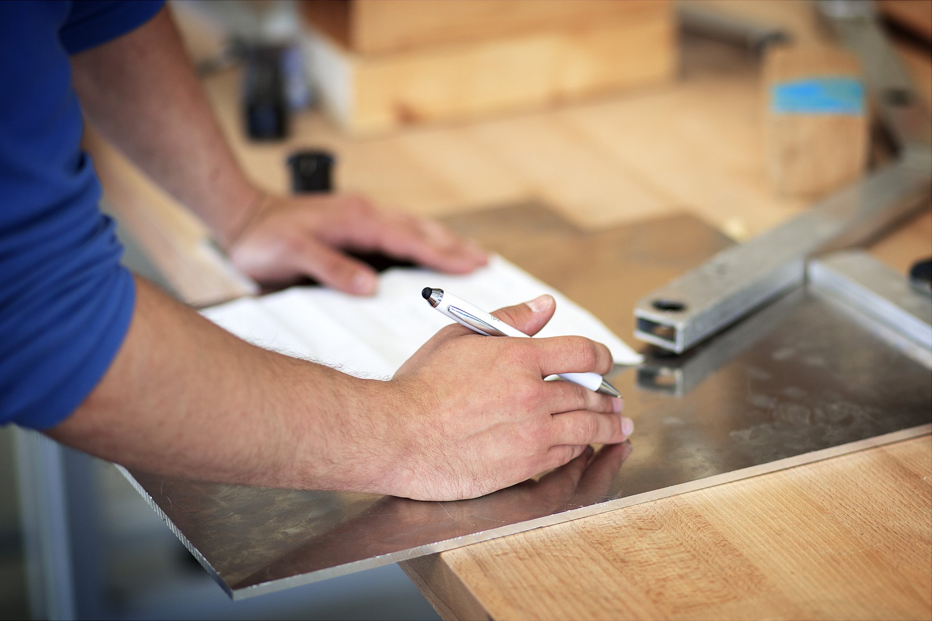 Person writes technical notes on paper