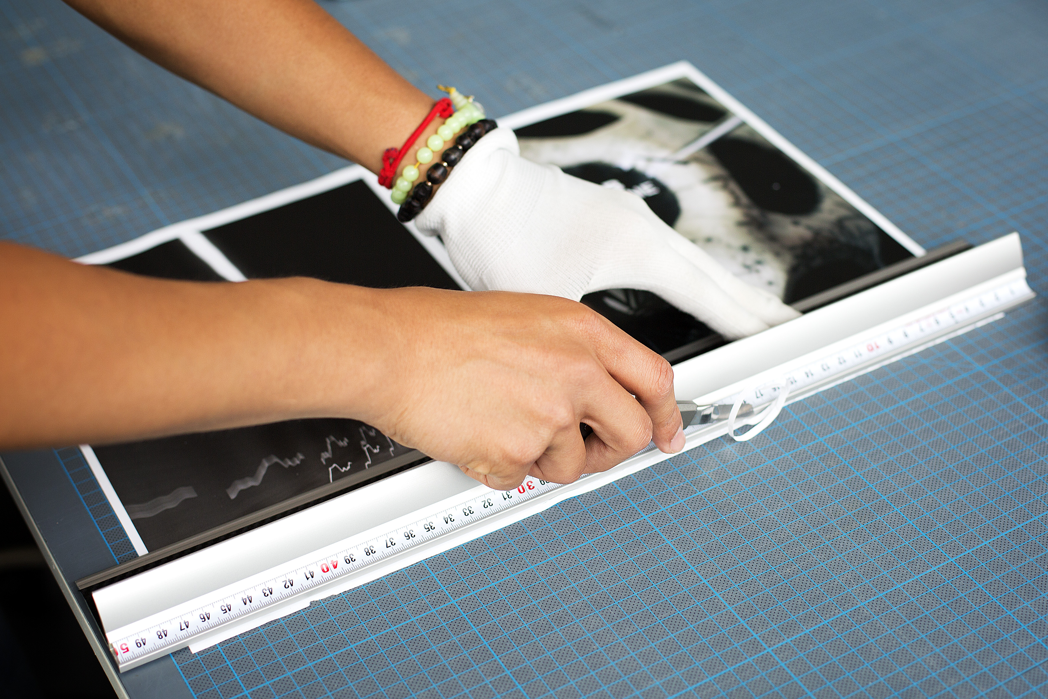 Person cuts a poster with a knife