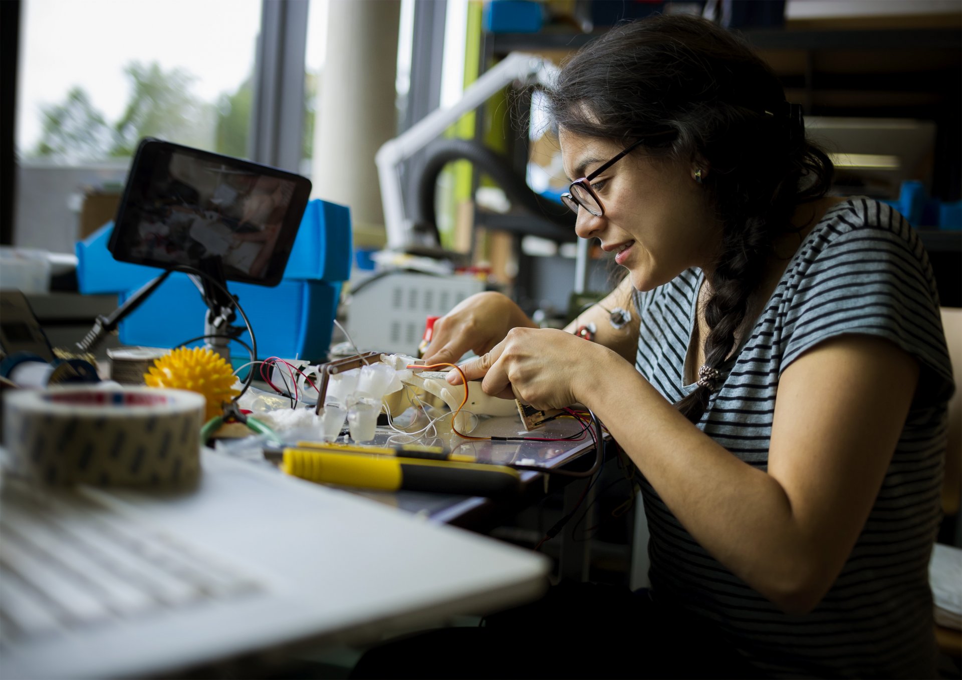 Person assembles a prototype of a robotic hand